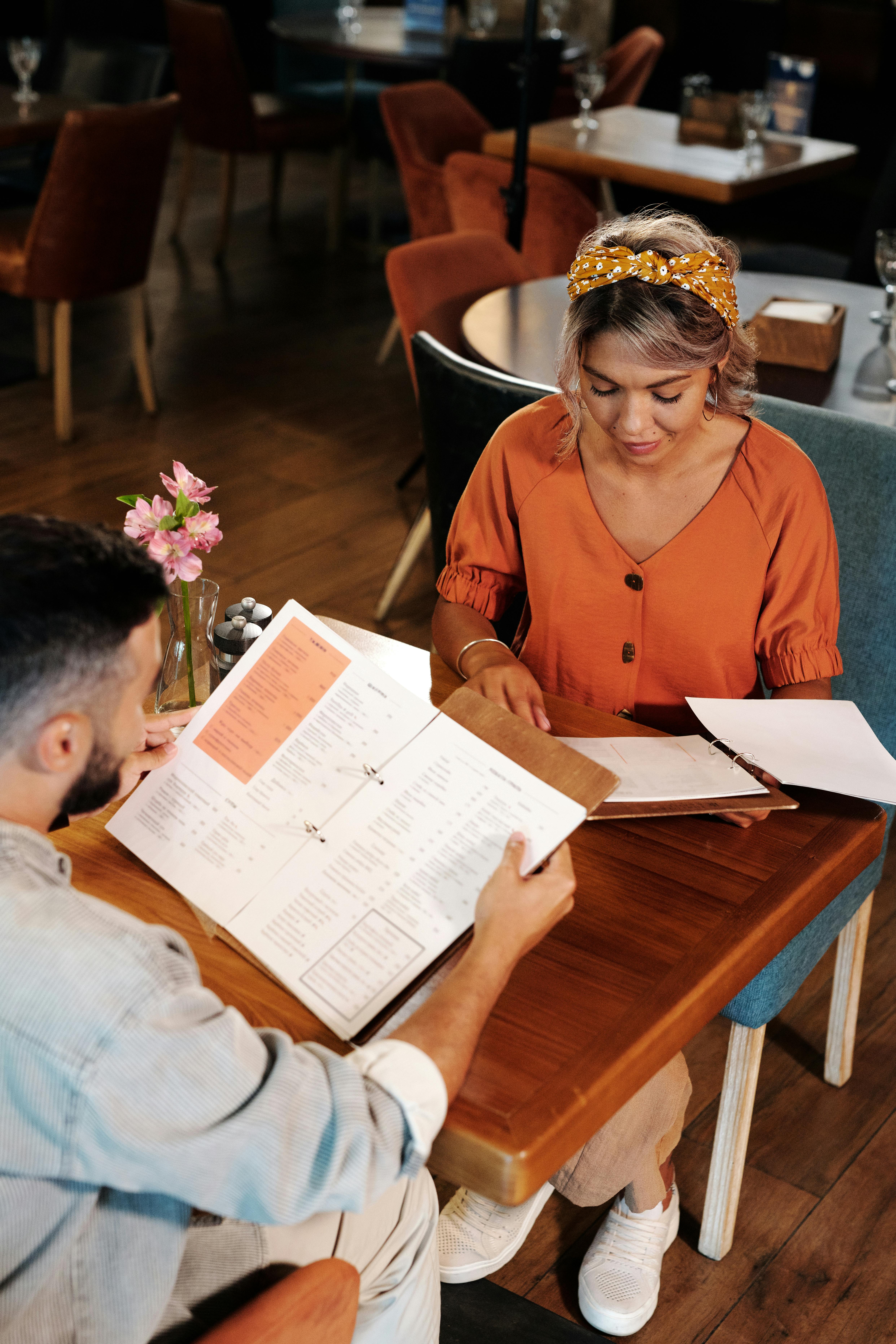 man and woman looking at the menu