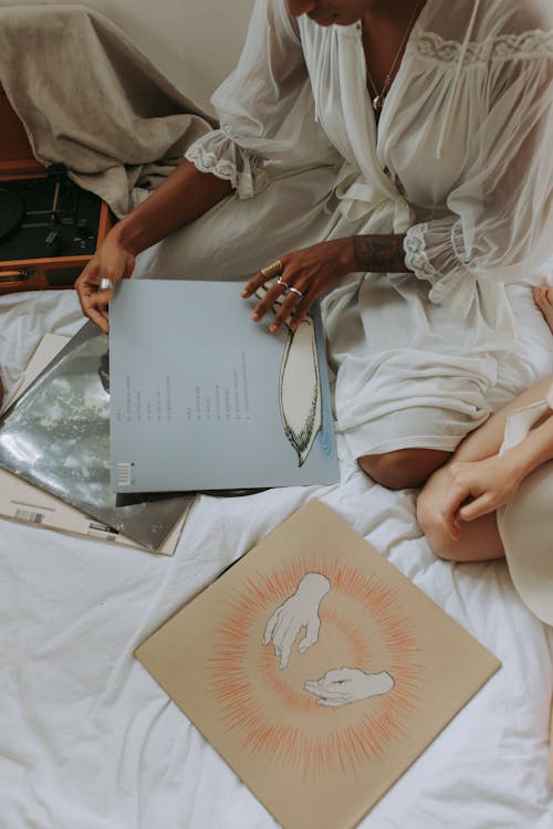 Woman in White Dress Shirt Choosing Vinyl 