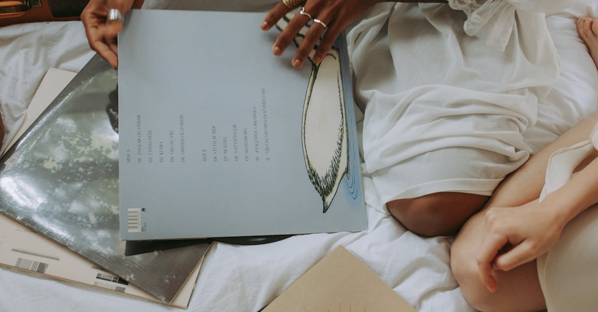 Two women enjoying vintage vinyl records on a bed, creating a retro vibe.