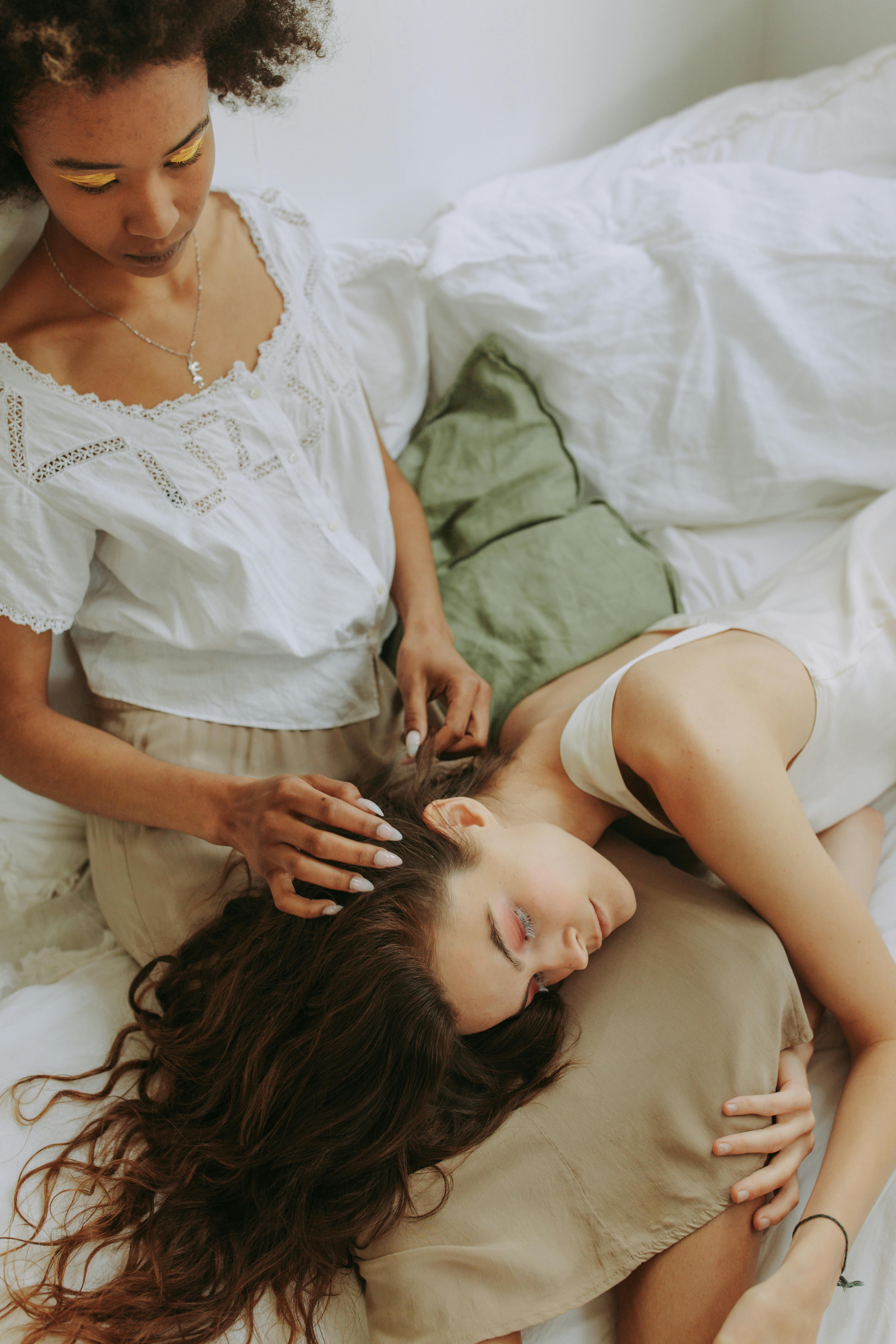 woman in white dress lying on bed