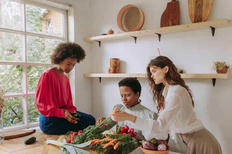 A Group Of Friends Having Conversation While Holding Mixed Vegetables