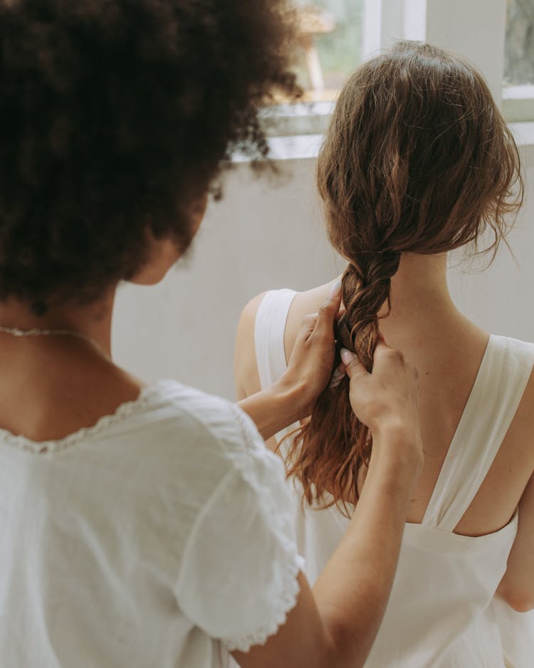 A Woman Braiding A Hair 