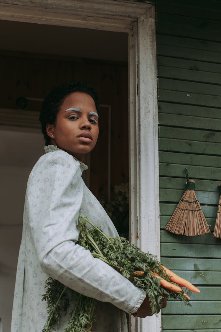 A Woman In White Long Sleeves Holding A Vegetables