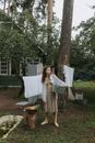 Woman in White Long Sleeve Dress Standing Near Tree