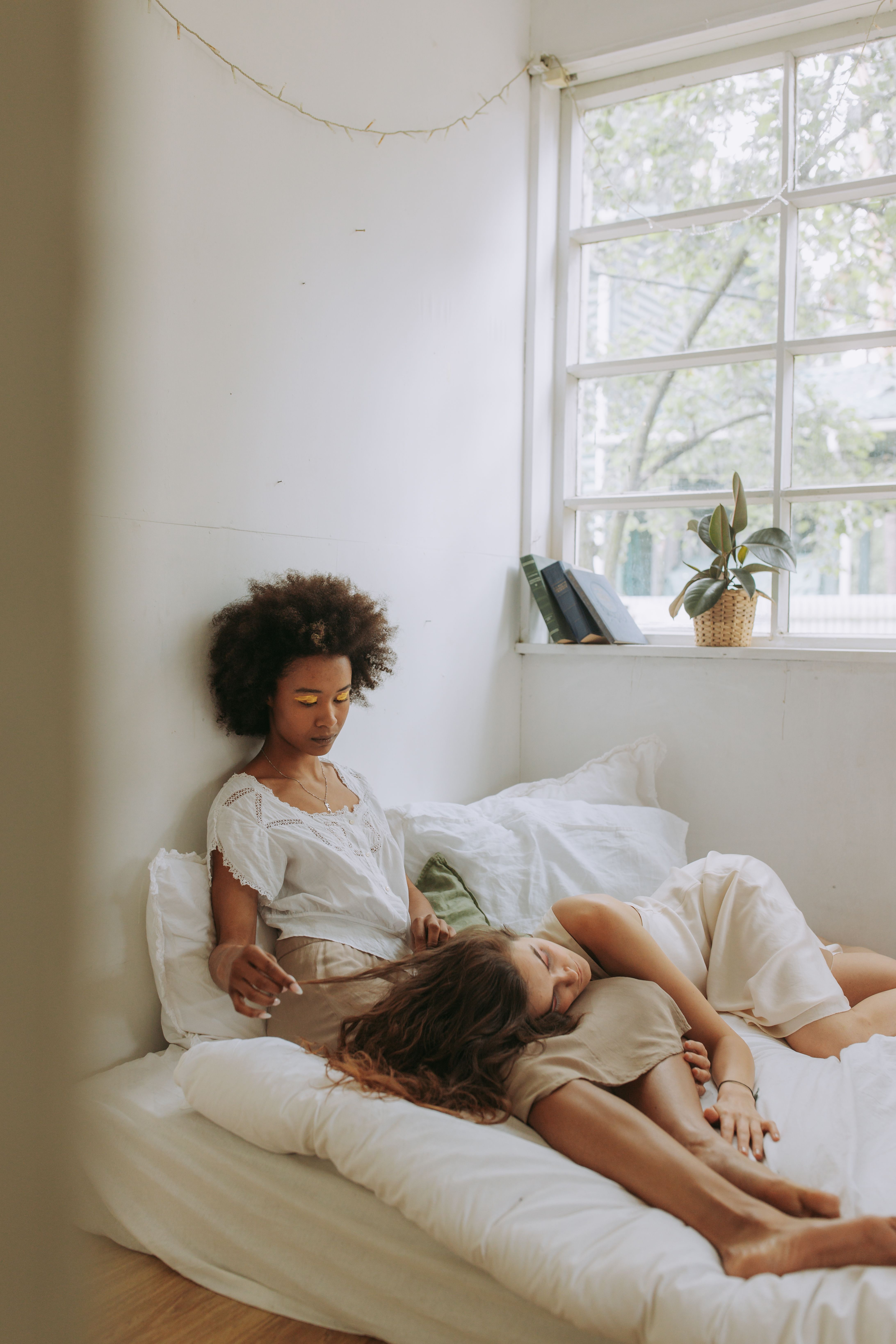 Woman in White Long Sleeve Shirt Lying on Bed · Free Stock Photo