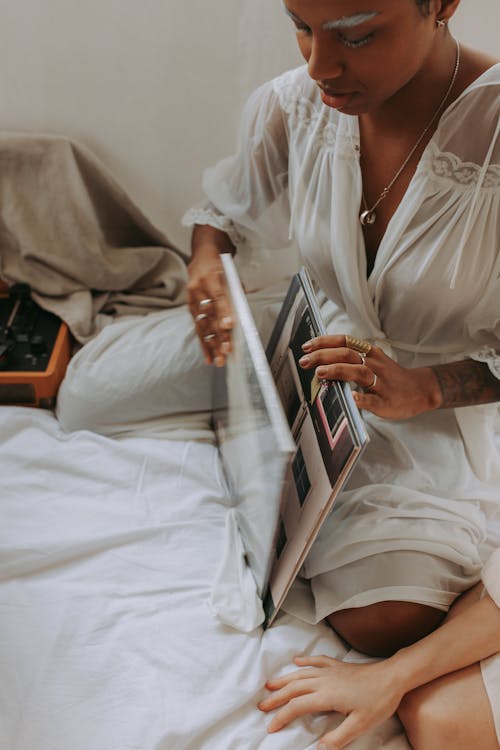 Woman in White Button Up Shirt Holding Silver Ipad