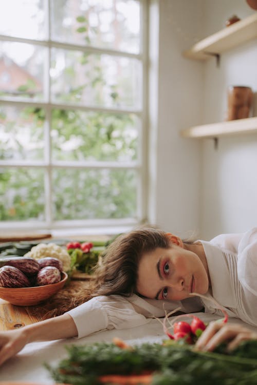 Girl in White Shirt Lying on Bed