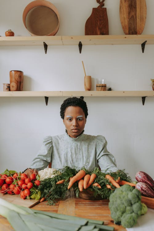 Boy in Gray Dress Shirt Holding Green Vegetable