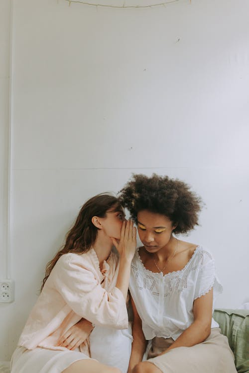 Free Person Whispering Near the Woman's Ear  Stock Photo