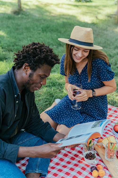 A Couple Reading a Book while in the Park