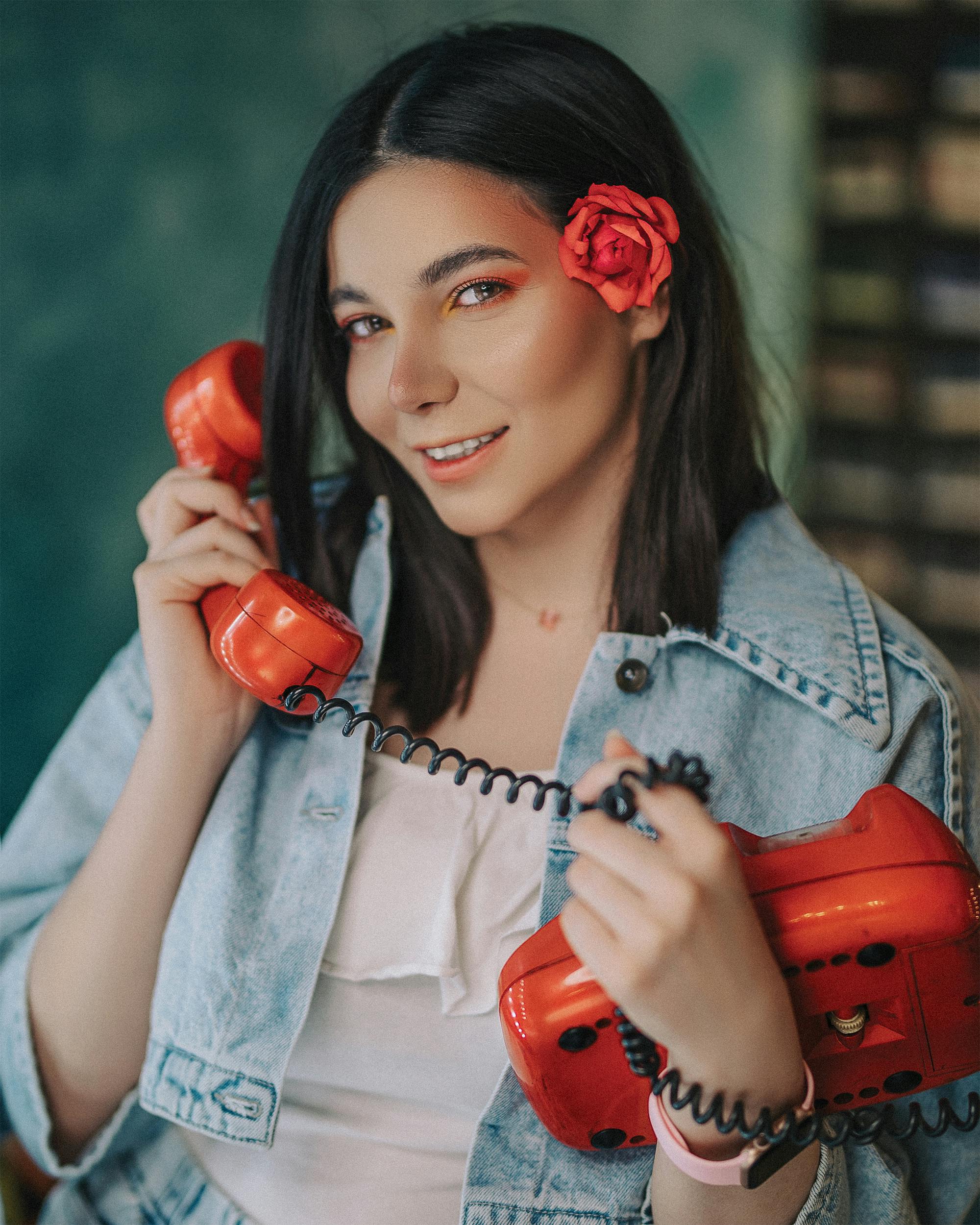 cheerful female talking on retro phone