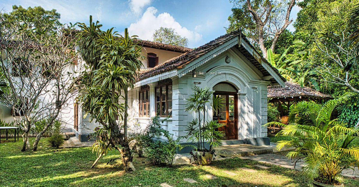 Colonial-style house surrounded by lush tropical garden in Unawatuna, Sri Lanka.