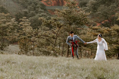 Free Happy newlywed having fun in field Stock Photo