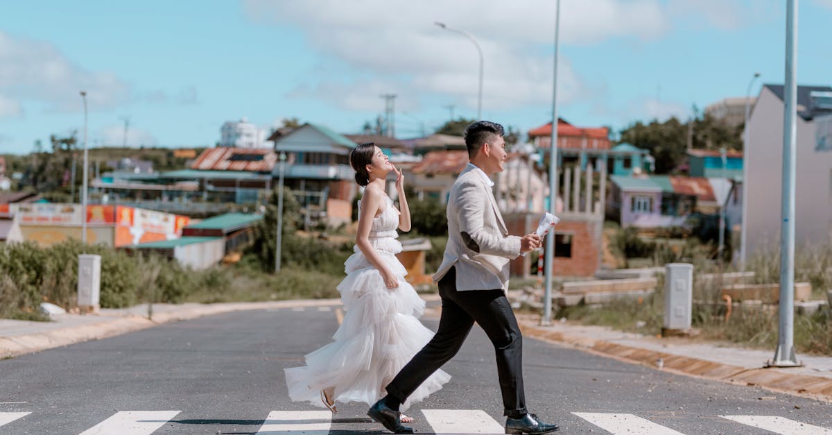 Happy ethnic newlyweds on road in city