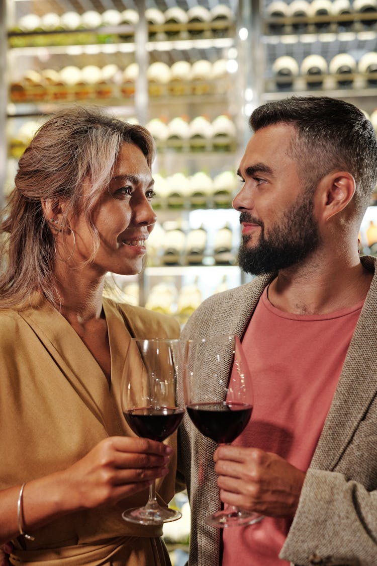 Couple Toasting With Red Wine Glasses