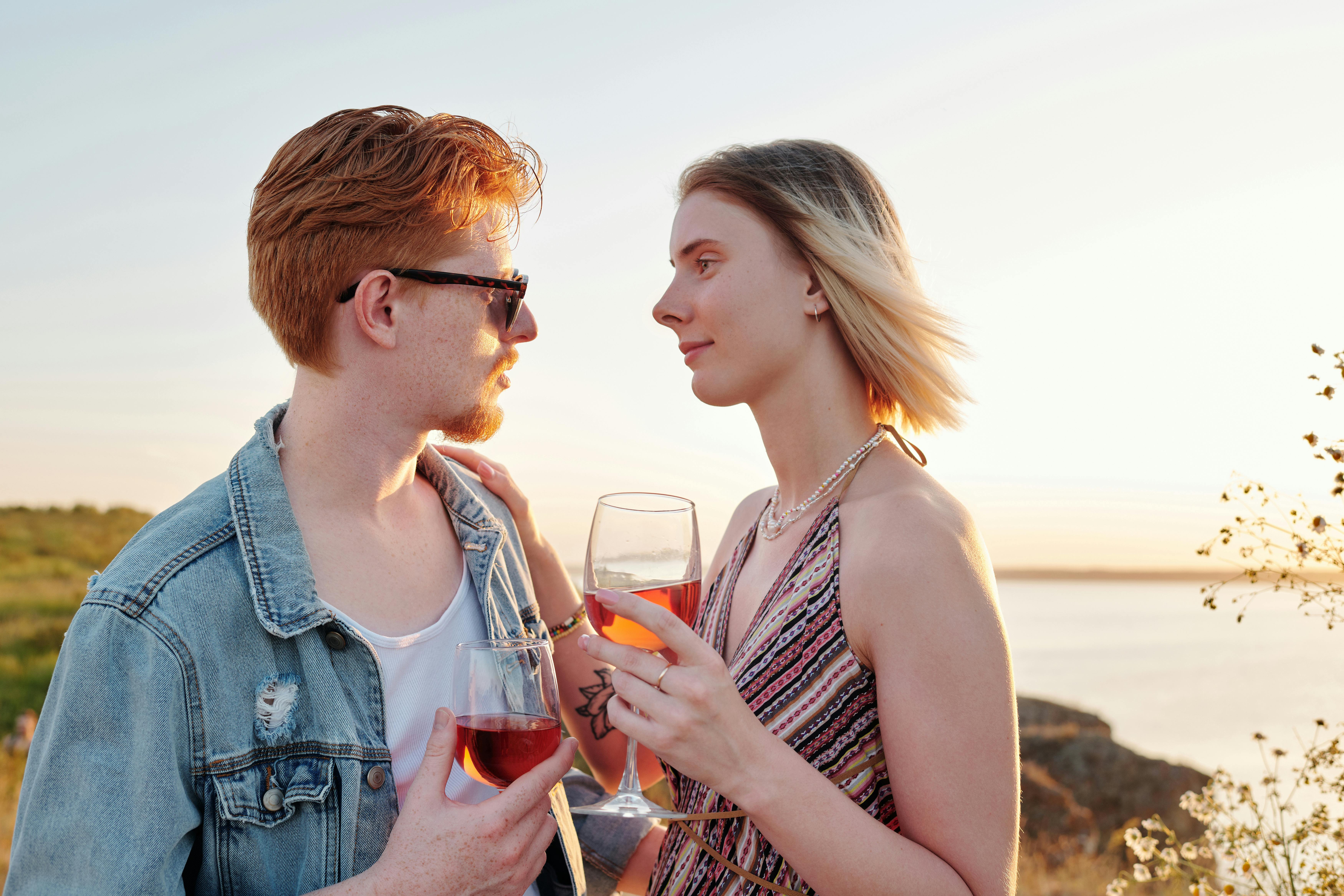 couple holding wine glasses