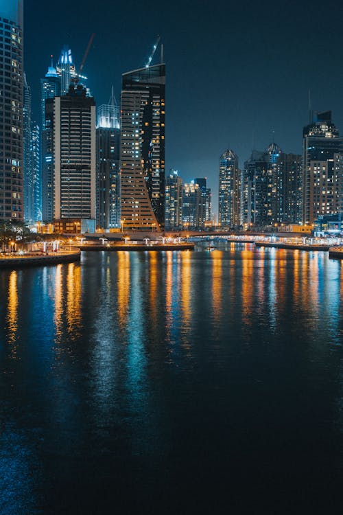 Free City Skyline Across Body of Water during Night  Stock Photo
