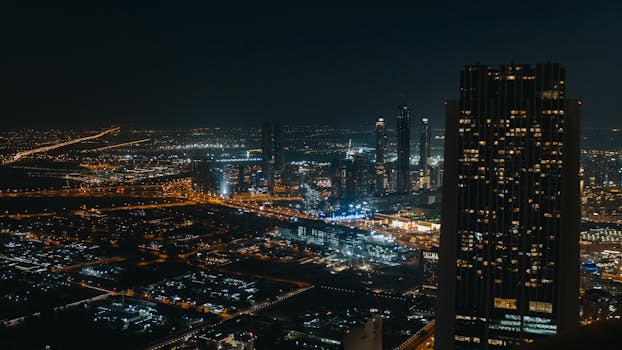 Captivating cityscape view with skyscrapers and glowing lights under the night sky. Aerial perspective showcases urban beauty.