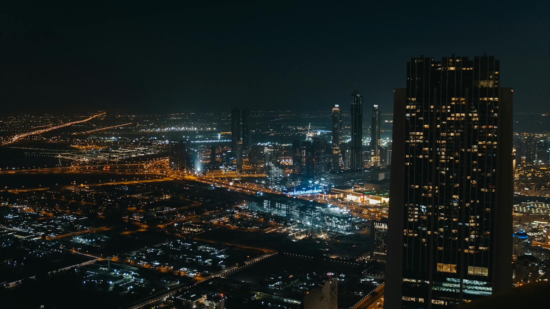 Captivating cityscape view with skyscrapers and glowing lights under the night sky. Aerial perspective showcases urban beauty.