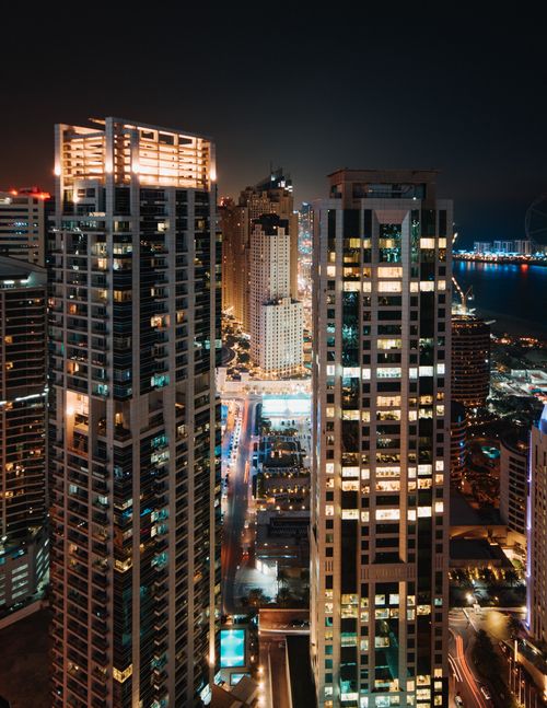Free A breathtaking aerial view of illuminated skyscrapers at night overlooking the cityscape. Stock Photo