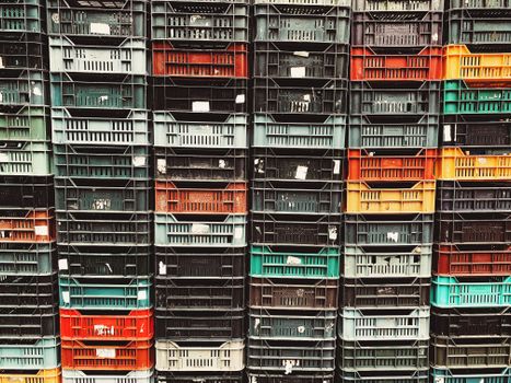 Vibrant stack of plastic storage crates showcasing various colors and textures.