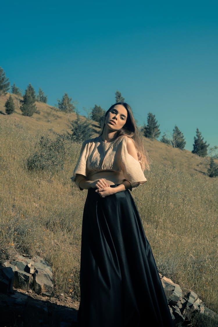 Gorgeous Woman In Dress Walking In Grassy Field