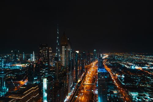 Free Stunning aerial view of Dubai's skyline at night, featuring illuminated skyscrapers and bustling highways. Stock Photo