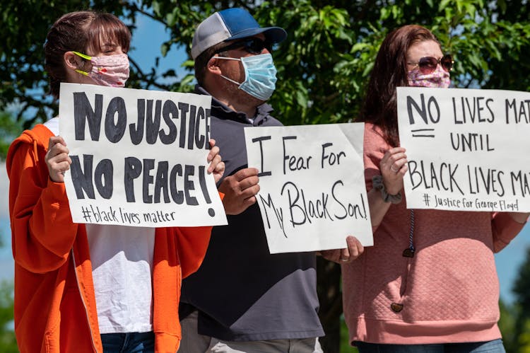 Diverse Protesters With Placards Participating In Meeting