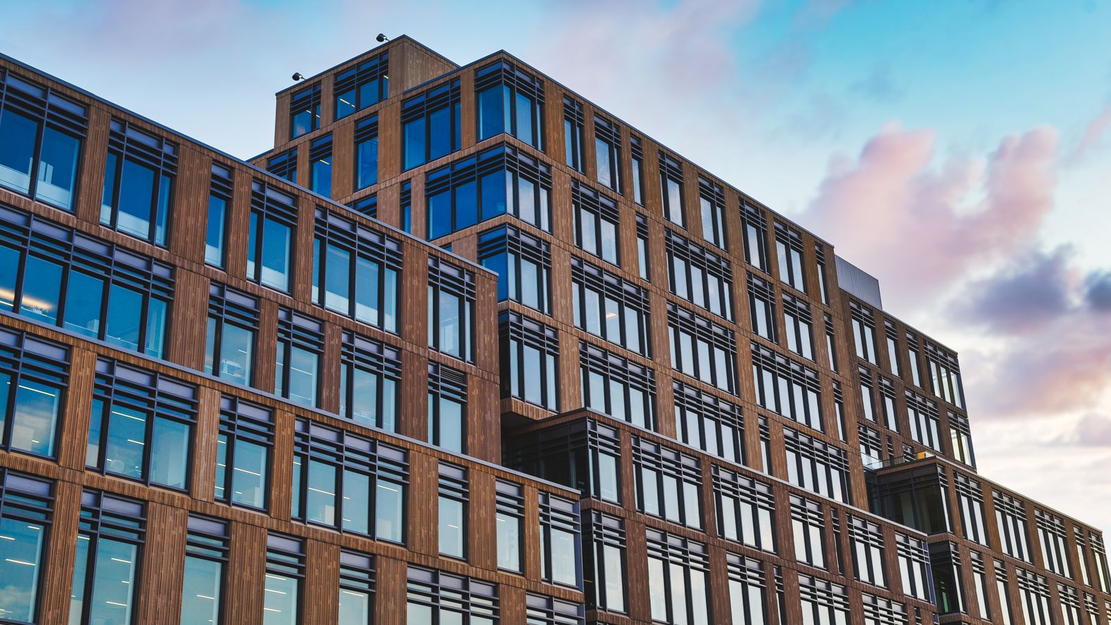 Exterior of big office building in modern design style under clear blue sky