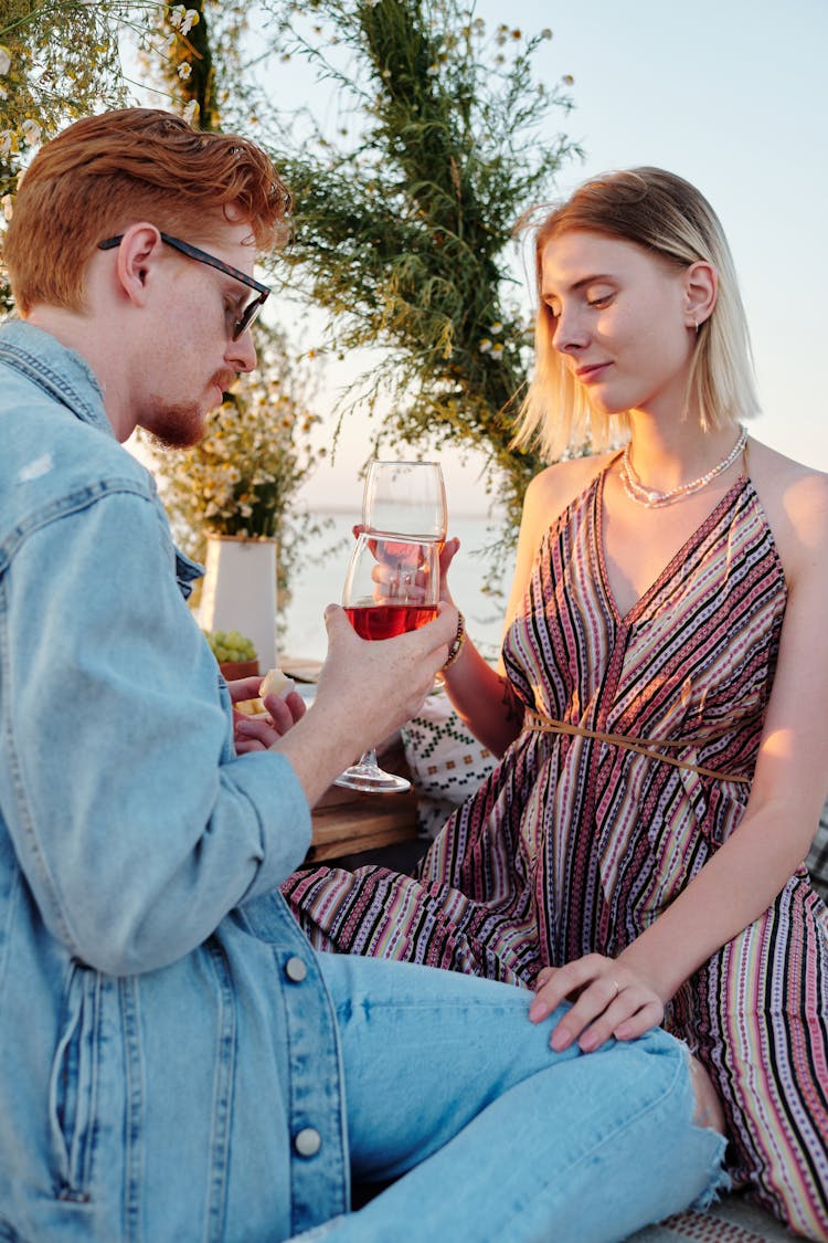 A Romantic Couple Holding Wine Glasses