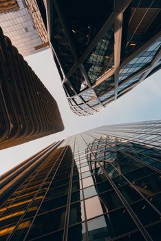 Low angle view of skyscrapers showcasing modern architecture and reflective glass facades.
