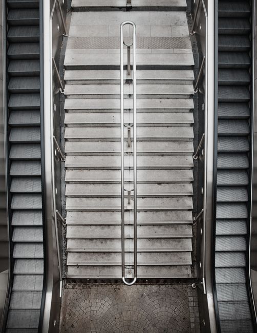 High-angle view of escalators and stairs in a modern indoor setting.