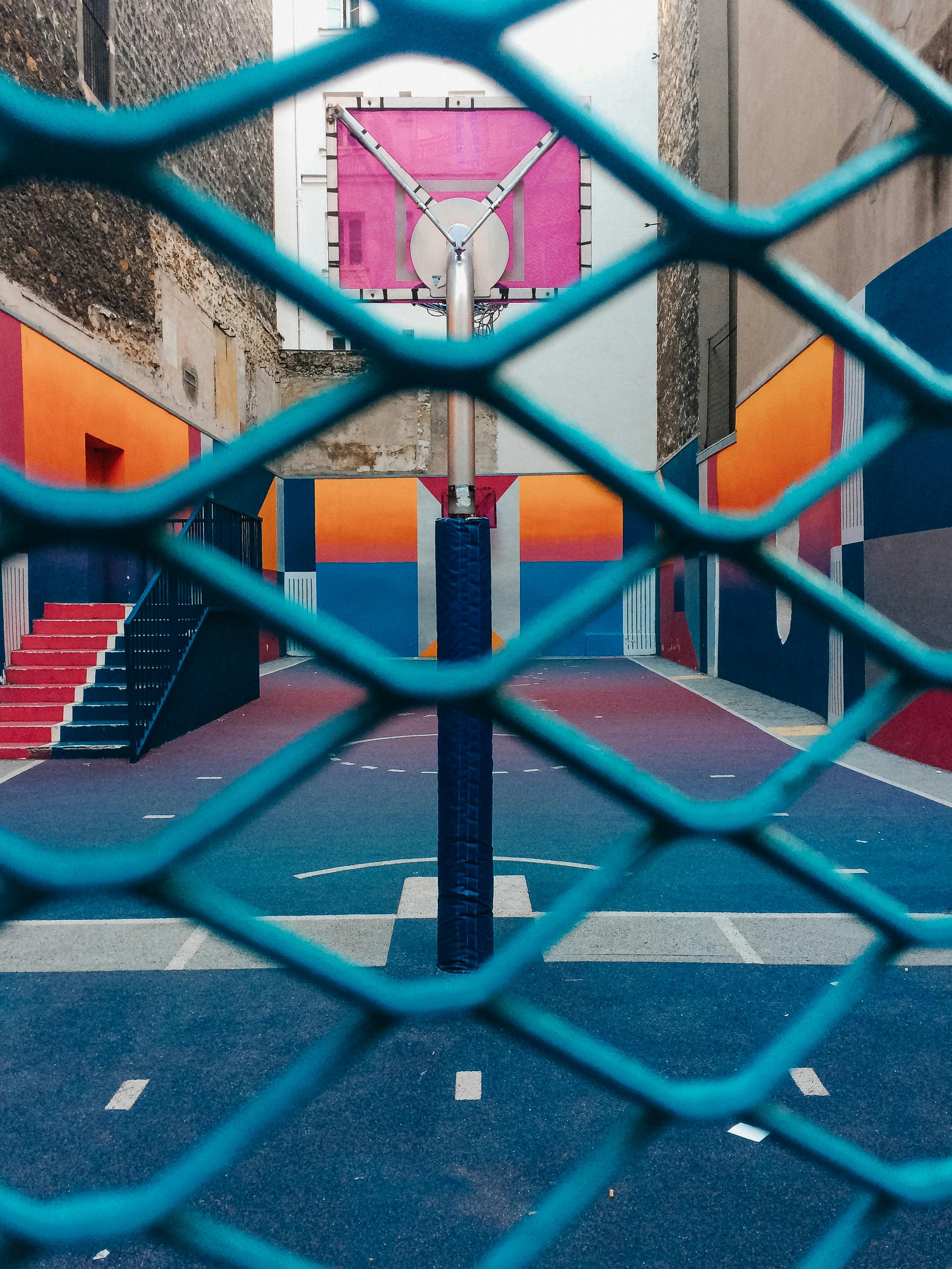 A Basketball Court Behind the Metal Fence · Free Stock Photo
