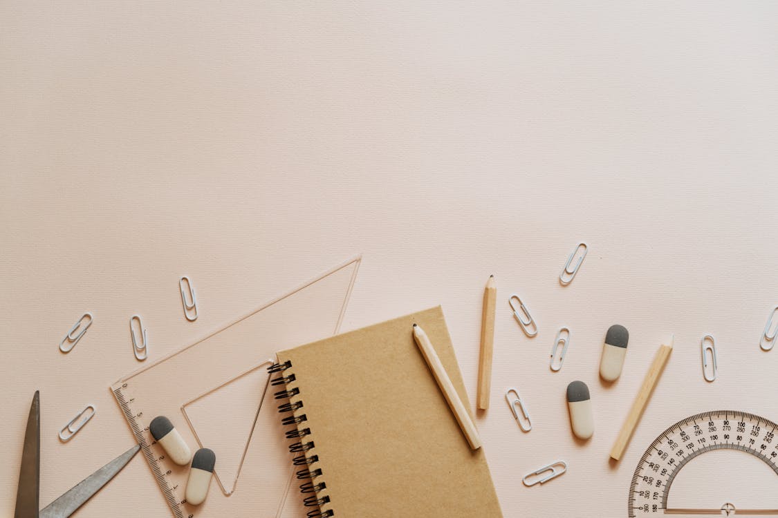 Free Spiral Notebook Pencils and Paper Clips Flatlay Stock Photo