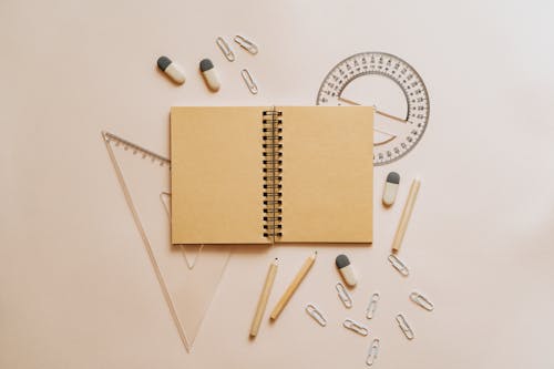Free Spiral Notebook Pencils and Paper Clips Flatlay Stock Photo