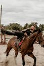 Man in Black Jacket Riding Brown Horse