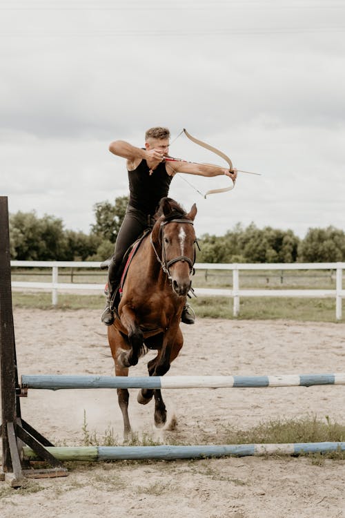 A Man Shooting an Arrow While Riding a Horse