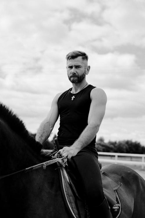 Grayscale Photo of Man Riding a Horse · Free Stock Photo