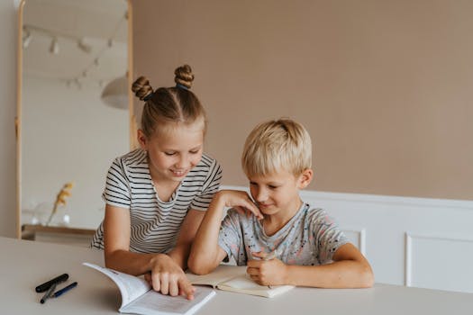 Two kids studying together at home, focusing on a book in a calm, indoor setting.