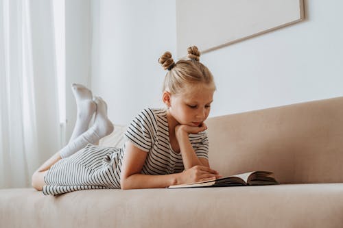 Free Little Girl Reading a Book Stock Photo