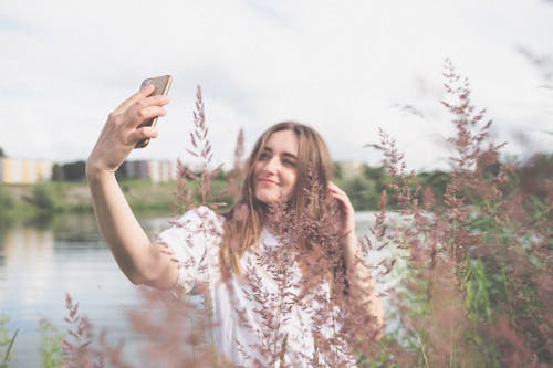 Beautiful Woman Taking Selfie Using a Cellphone