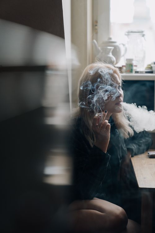 A Blonde-Haired Woman Smoking · Free Stock Photo