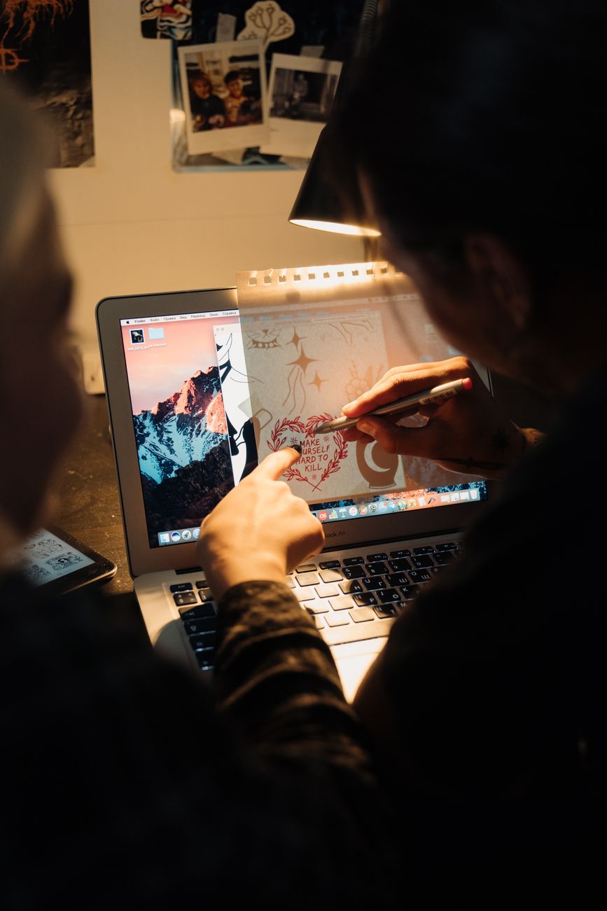 Designer developing a visual identity through digital and hand-drawn work
