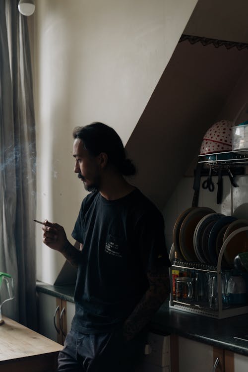 Free Pensive Man Smoking In The Kitchen  Stock Photo