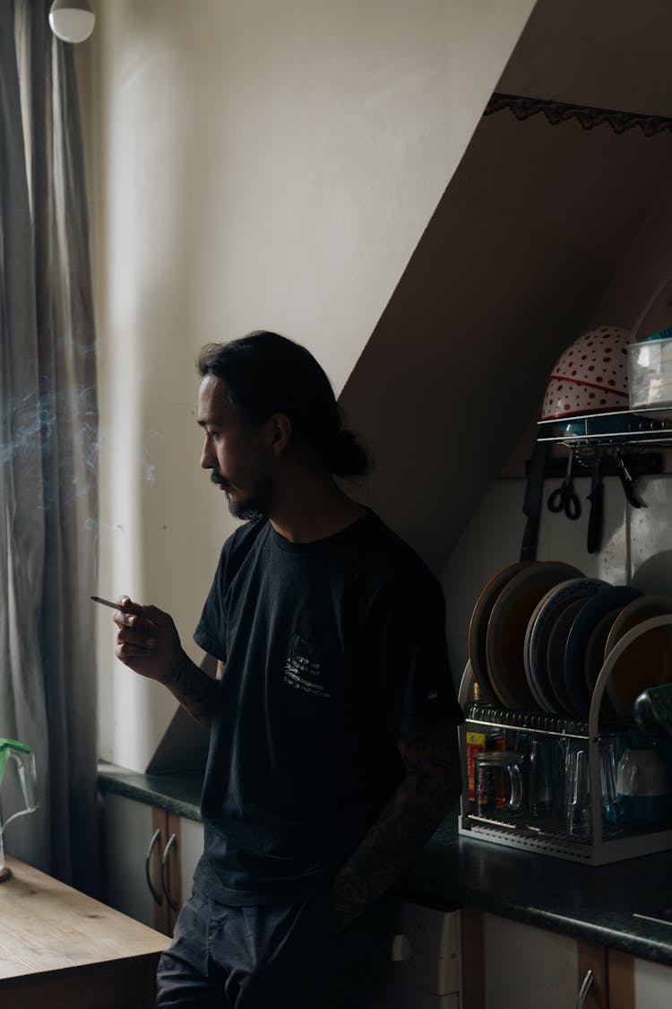 Pensive Man Smoking In The Kitchen 