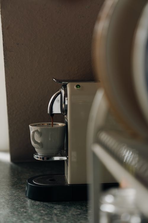 Free Close-up of a coffee machine preparing a fresh cup of espresso indoors. Stock Photo