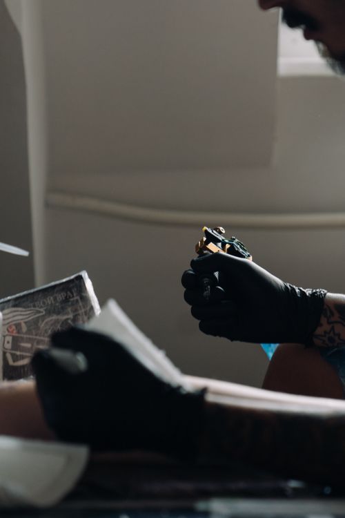Tattoo artist preparing equipment
