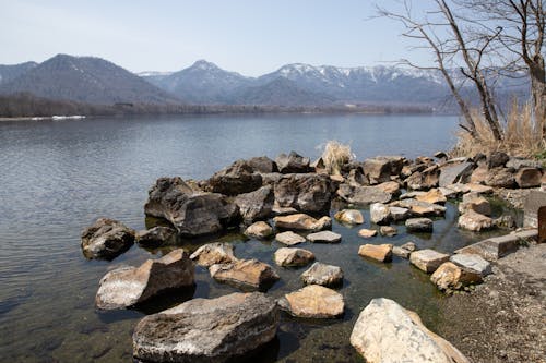 Free Boulders of Rock on the Lakeside Stock Photo