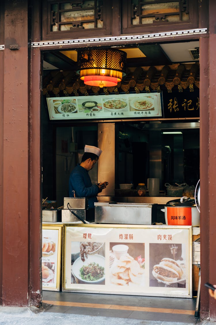 A Man Standing Inside The Restaurant