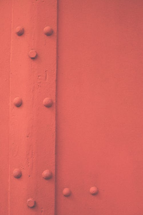 Close-Up Shot of a Red Metal Door